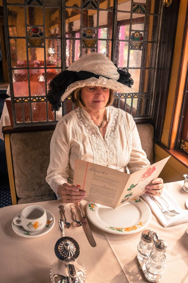Acwr Tour Woman Hat Reading Menu Dining Car