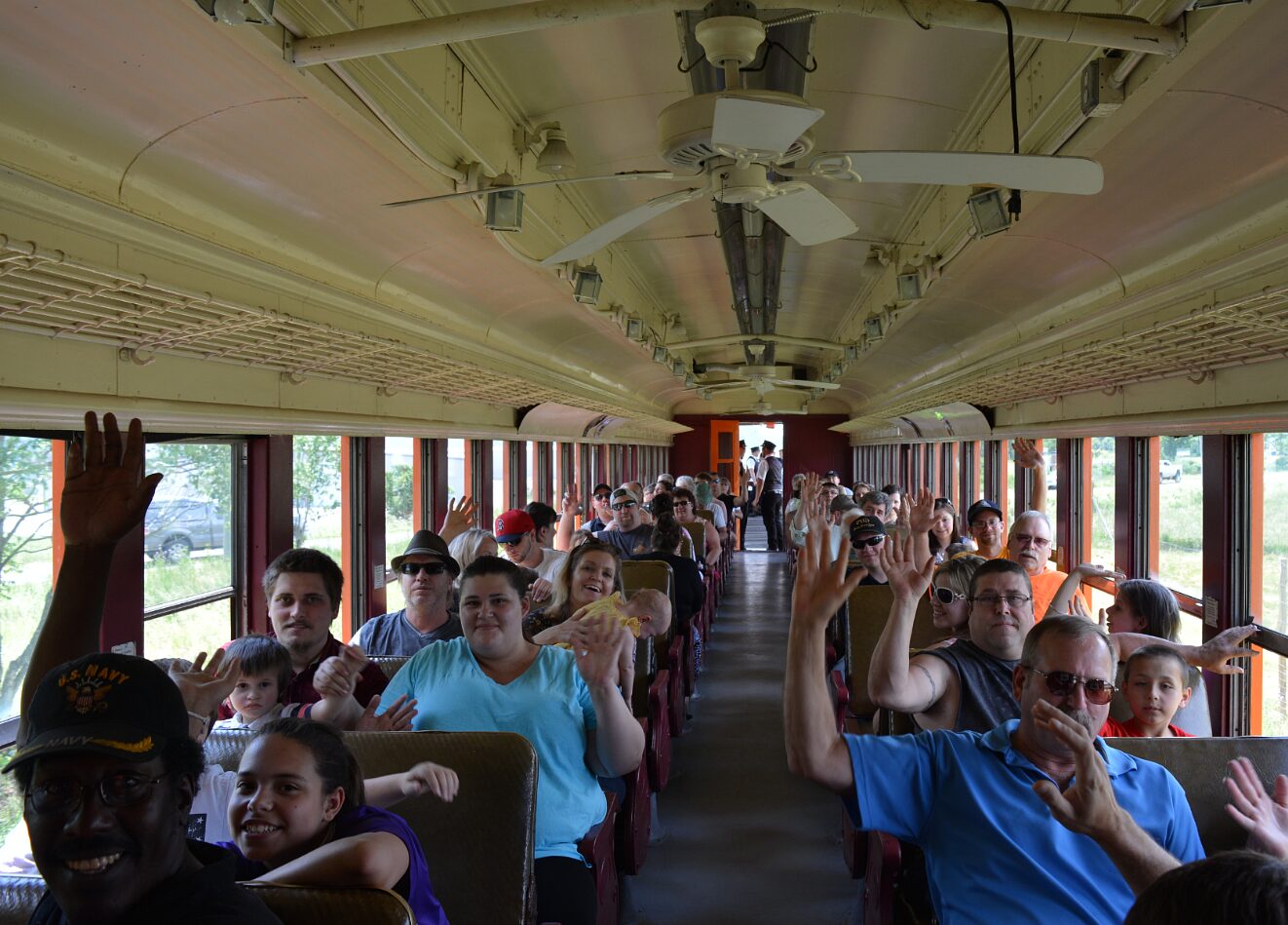 arcadeandatticarailroad_tour-train-passengers-waving-interior Arcadeandatticarailroad Tour Train Passengers Waving Interior