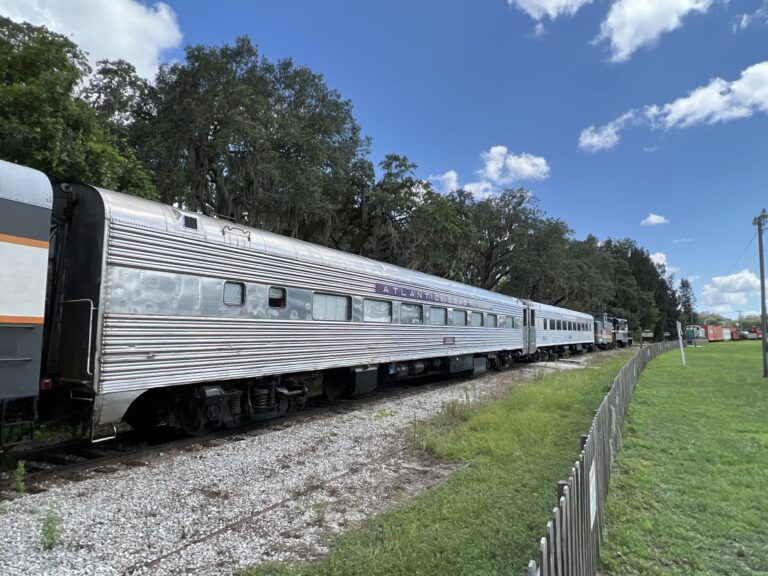 Frrm Tour Silver Train Cars Grassy Area