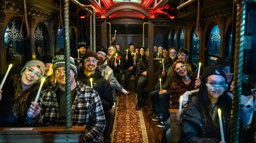 minneapolistrolleytours_tour-trolley-ride-passengers-lit-candles Minneapolistrolleytours Tour Trolley Ride Passengers Lit Candles