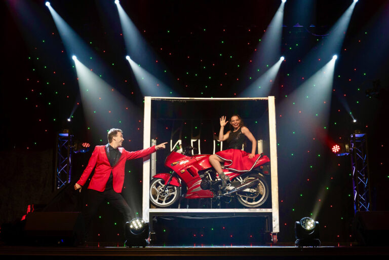 Mountainofentertainmenttheater Tour Magician Red Suit Motorcycle Stage