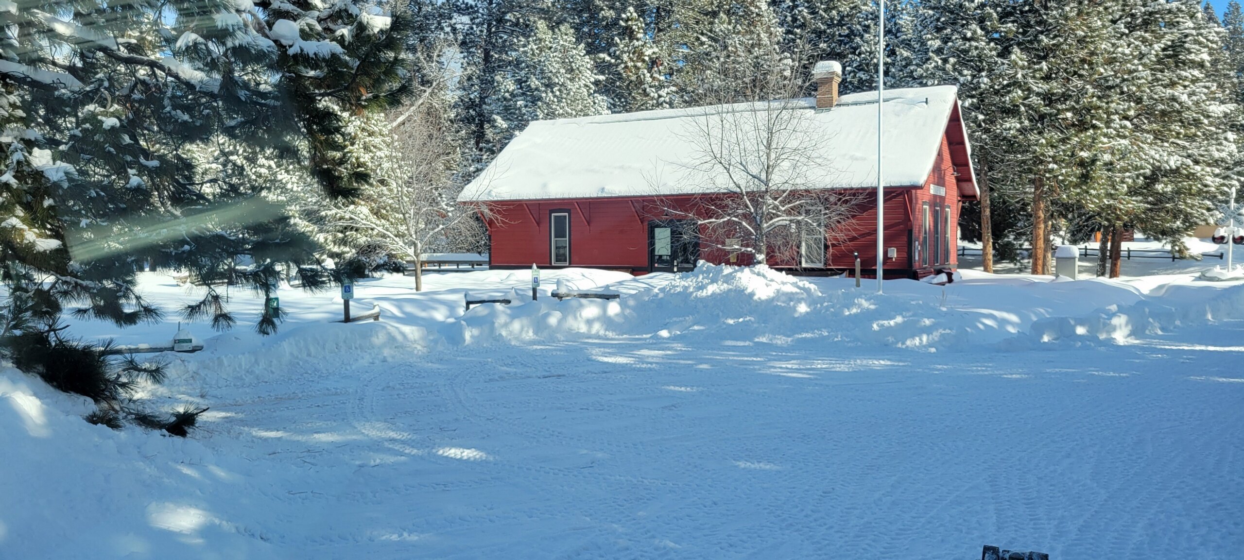 Sumptervalleyrailroad Tour Red Building Snowy Landscape Pine Trees